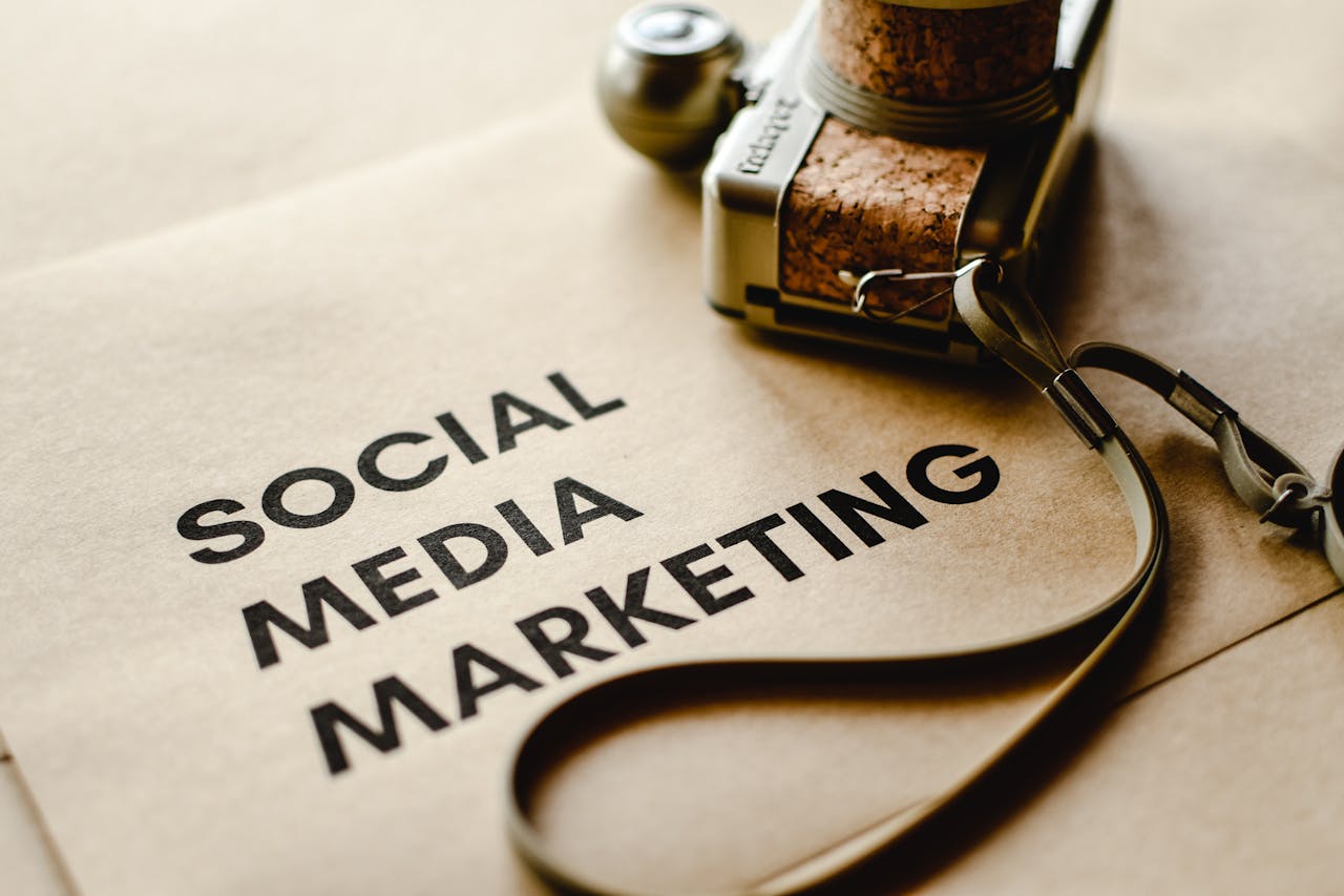 services-04 Close-up of a camera placed on brown paper with Social Media Marketing text, emphasizing digital marketing themes.