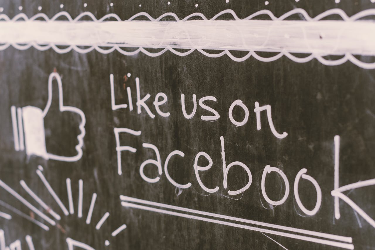 hero-img Chalkboard art promoting Facebook engagement with a like us message.
